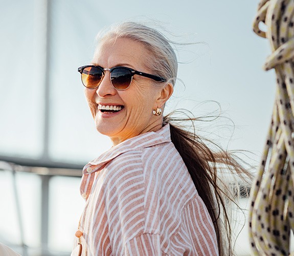 Woman in pink blouse with dentures in Naperville