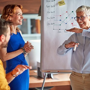 Female professional presenting before her team at work