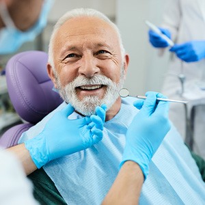 Man allowing dentist to perform checkup