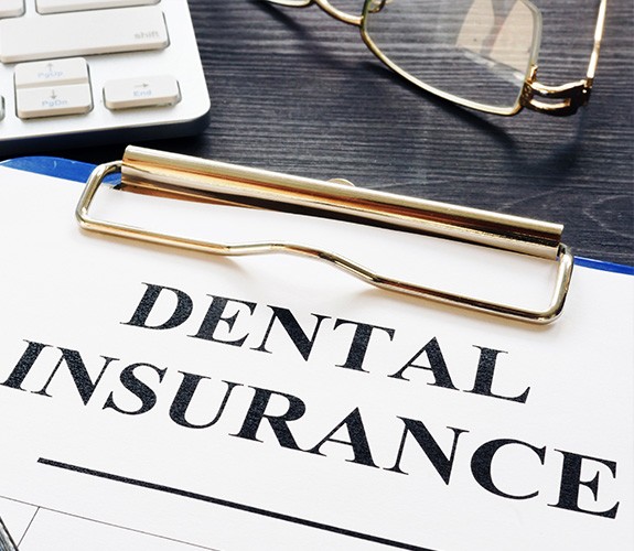 Dental insurance forms on a clipboard