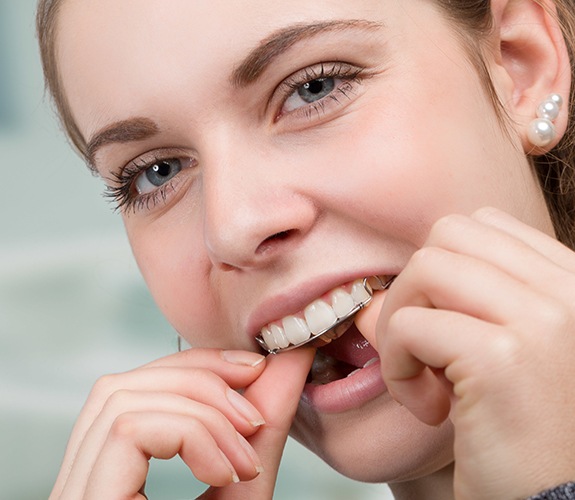 Woman placing her orthodontic appliance
